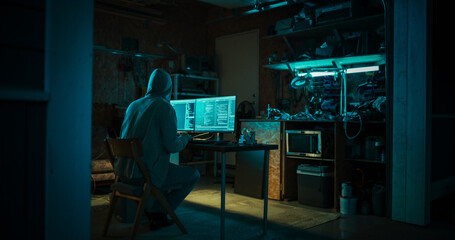 Home Garage Late At Night: Evil Male Hacker Wearing Hoodie Breaks into Data Servers, DDOS Attack,...