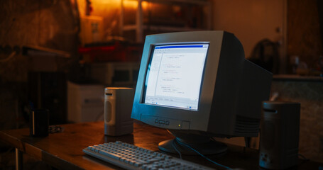 Close Up Shot Of Old Desktop Computer On Work Desk Of Software Developer In Retro Garage. Dated PC...