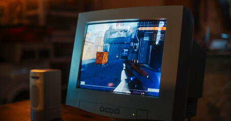Close Up Of Old Desktop Computer With 3D First-Person Shooter Video Game In Retro Garage Late At...