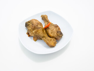 Spicy sweet and sour fried chicken in a white plate on a white background