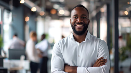 Portrait of a handsome smiling black businessman boss standing in his modern business company office. - obrazy, fototapety, plakaty