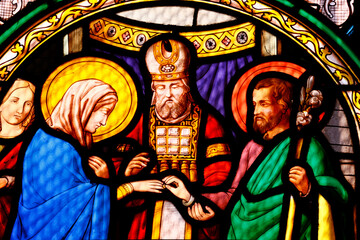 Saint Leonard church.  Stained glass.  The Marriage of the Virgin Mary and Saint Joseph. Arbois. France. - obrazy, fototapety, plakaty