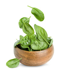 wooden plate with falling spinach leaves on a white isolated background