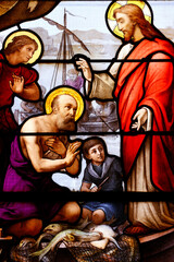Saint Aubin church.  Stained glass. Jesus and his apostles fishing. The Miraculous catch of fish. Houlgate. France.