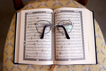 Arabic open Quran with glasses.  France.