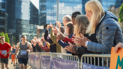 Marathon Audience Supporting and Cheering Their Loved Ones Participating in the Race: Athletic Male...