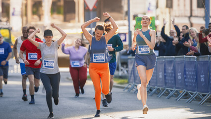 Women Supporting Women: Portrait of Happy Female Runners Participating in a Marathon. Group of Friends Celebrating Together and Congratulating Each Other on Crossing the Finish Line