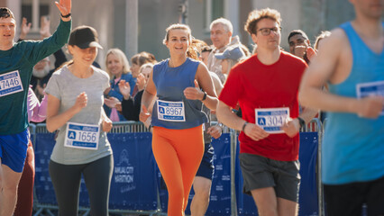 Portrait of a Group of People Participating in a Marathon and Running Through a City Trail. Joggers Giving their Best to Achieve the Finish Line in a Friendly Race
