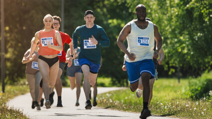 Diverse Marathon Participants Competing in a Race for the Finish Line: Group of People Running...