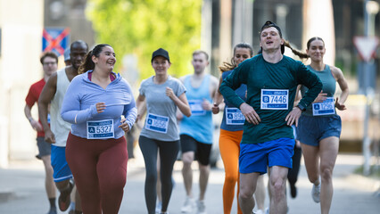 Group of Diverse People Running in a Marathon with the Cheers of their Loved Ones and Supporters in...