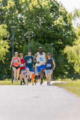 Obraz premium Wide Shot of Diverse Marathon Participants Competing in a Race for the Finish Line: Group of People Running Through Park Health Trail and Participating in a Marathon with Dedication
