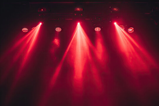 Free stage with lights and smoke, Empty stage with red spotlights, conser, show, party, Presentation concept.  Red spotlight strike on black background 