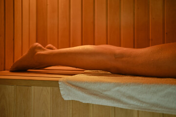 Bare female legs in sauna