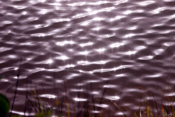 Shining sun water reflection. Glare river dynamic background.