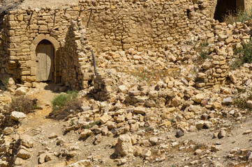 Jordan. Fragments of stone walls of buildings in village of Dana, located on edge of the large natural canyon Wadi Dana. Dana Biosphere Reserve, one of leading ecotourism reserves in Jordan.