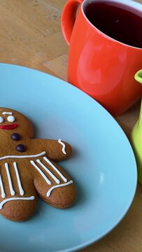 bright dishes pour red tea Hibiscus near the gingerbread man gift Christmas. delicious