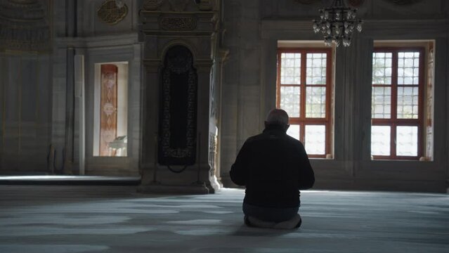 Muslim Man Salah salat Pray inside Nuruosmaniye Camii Mosque Architecturally significant Ottoman mosque Istanbul, Turkey