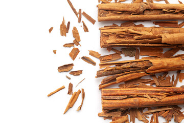 Top view of Dry organic Cinnamon sticks (Cinnamomum verum) isolated on a white background presented over a gradient background of itself.