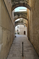 Fototapeta na wymiar A narrow street among the old houses of Monopoli, a town in the province of Bari, Italy.