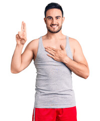 Young handsome man wearing swimwear and sleeveless t-shirt smiling swearing with hand on chest and...