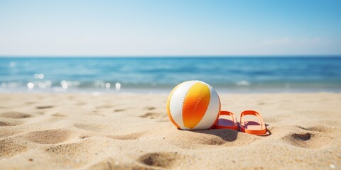 Beach slippers beach ball on the sand