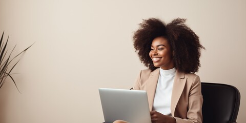 Image of a cheerful African American woman using a laptop