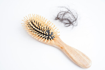Asian woman have problem with long hair loss attach to comb brush.