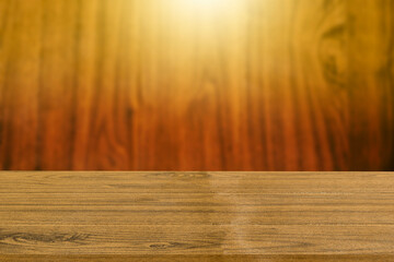 Wooden tabletops separate blurred backgrounds for coffee and produce in a cafe.