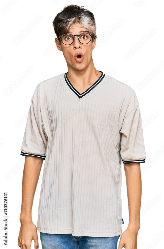 Canvas Prints Young hispanic man wearing casual clothes and glasses scared and amazed with open mouth for surprise, disbelief face