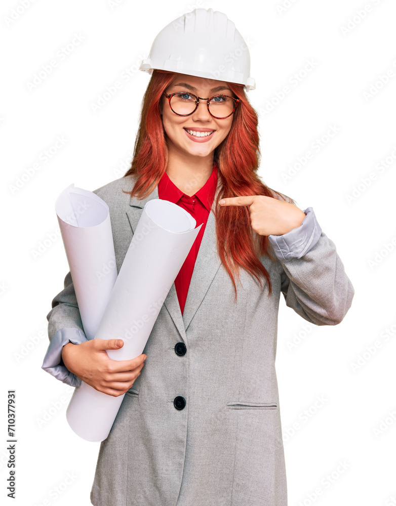 Sticker young redhead architect woman wearing safety helmet holding blueprints pointing finger to one self s