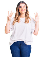 Young caucasian woman wearing casual clothes showing and pointing up with fingers number eight while smiling confident and happy.