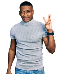 Young black man wearing casual t shirt showing and pointing up with fingers number three while smiling confident and happy.