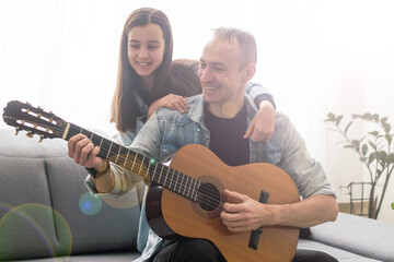 Artistic talented girl showing her latin music teacher the new song she learned to play on the...