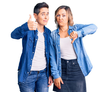 Couple of women wearing casual clothes doing thumbs up and down, disagreement and agreement expression. crazy conflict