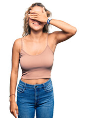 Beautiful caucasian woman wearing casual clothes smiling and laughing with hand on face covering eyes for surprise. blind concept.