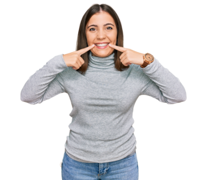 Young beautiful woman wearing casual turtleneck sweater smiling with open mouth, fingers pointing and forcing cheerful smile