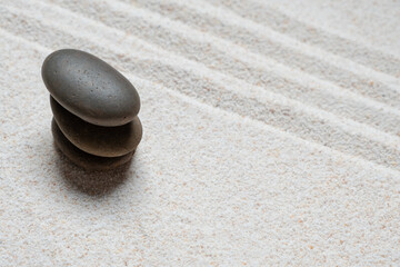 Top view of three stones resting on sandstone balance concept, Japanese Zen garden.	
