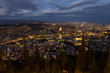 Panoramic landscape of Tbilisi capital of Georgia at nigh after sunset with street light and lit churches