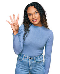 Young hispanic woman with curly hair wearing casual clothes showing and pointing up with fingers number four while smiling confident and happy.