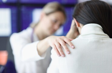 Physician holds upset patient's shoulder sympathetically. Psychological pressure with illness concept - obrazy, fototapety, plakaty