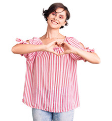 Beautiful young woman with short hair wearing casual summer clothes smiling in love doing heart symbol shape with hands. romantic concept.