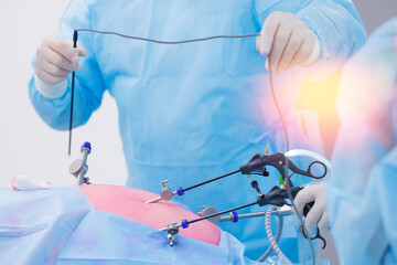 Doctor surgeon holding laparoscopic instrument in abdomen of patient. Minimally invasive surgery,...