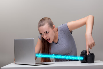 Young woman transfers files from camera to laptop in badass, coo