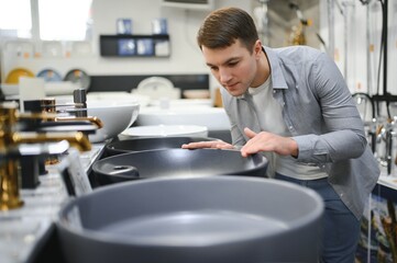 Man at the building market looking for sink into their bathroom