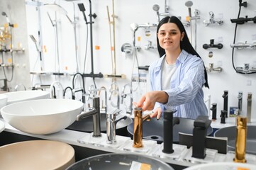 Woman choosing a shower head in a hardware store