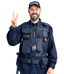Young handsome man wearing police uniform smiling looking to the camera showing fingers doing...
