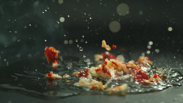Close up chili and garlic chopped put in frying pan by chef boiled oil splash and  hot,  slow motion 4k Phantom