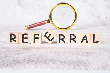 referral a word written on wooden cubes