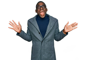 Young african american man wearing business clothes and glasses celebrating crazy and amazed for...