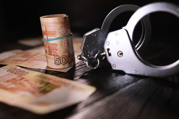 Handcuffs behind, five thousand rubles. Concept of corruption